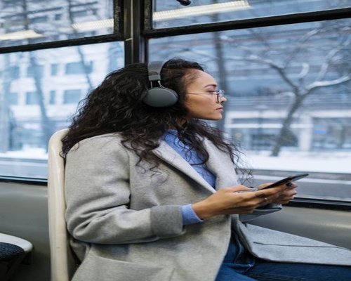 Commuting on a bus while looking at a smartphone