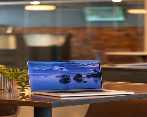 Laptop on a desk during an online meeting in a coworking space